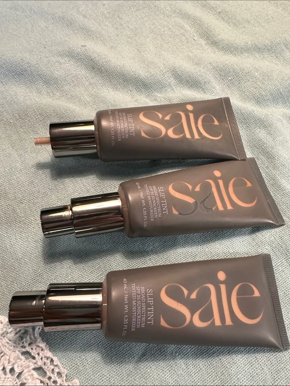 Saie Slip Tint Tinted Moisturizer Trio - Taupe & Rose Gold Accents